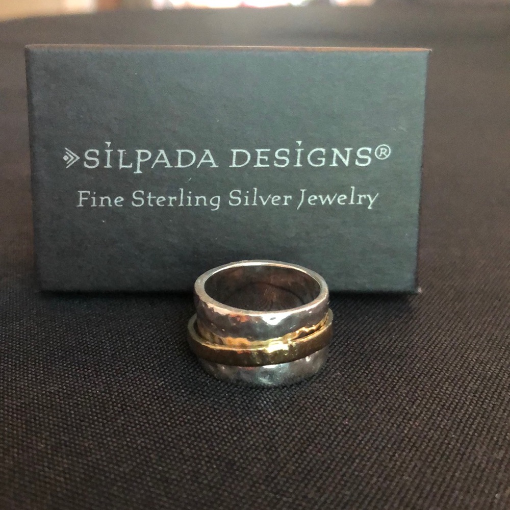 Hammered silver cuff ring with floating gold band.
